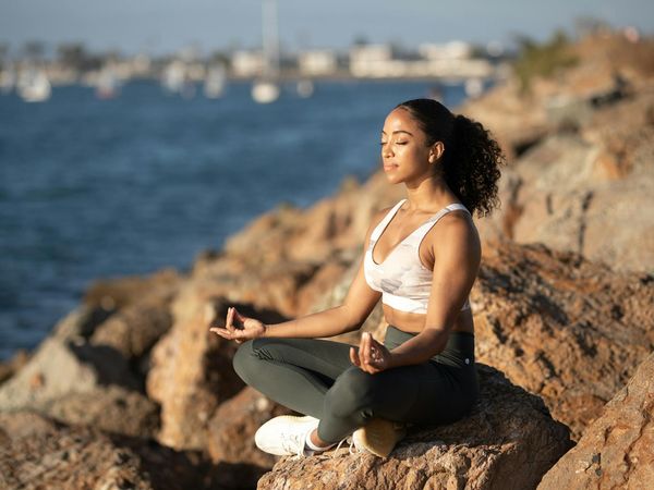 Profile of a woman with eyes closed, practicing deep breathing.